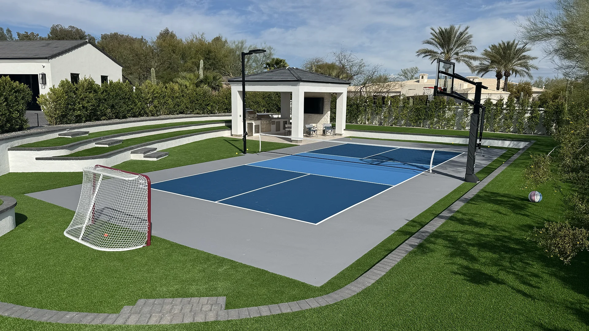 residential pickleball court with basketball hoop