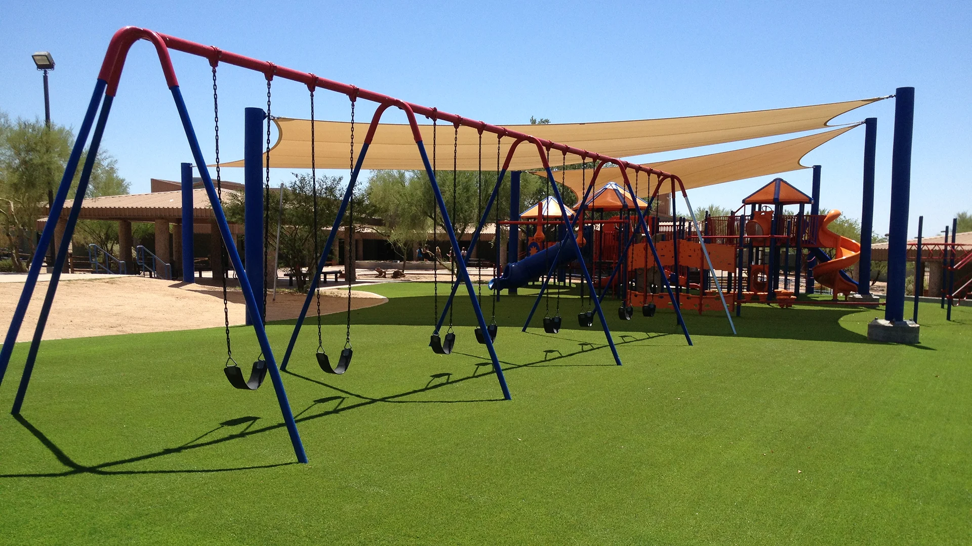 swingsets at an Arizona park with artificial turf