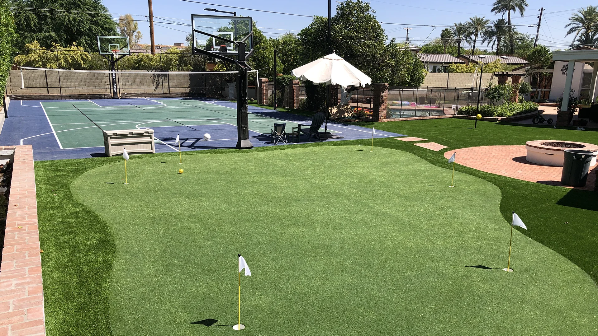 family outdoor space with a putting green and sport court