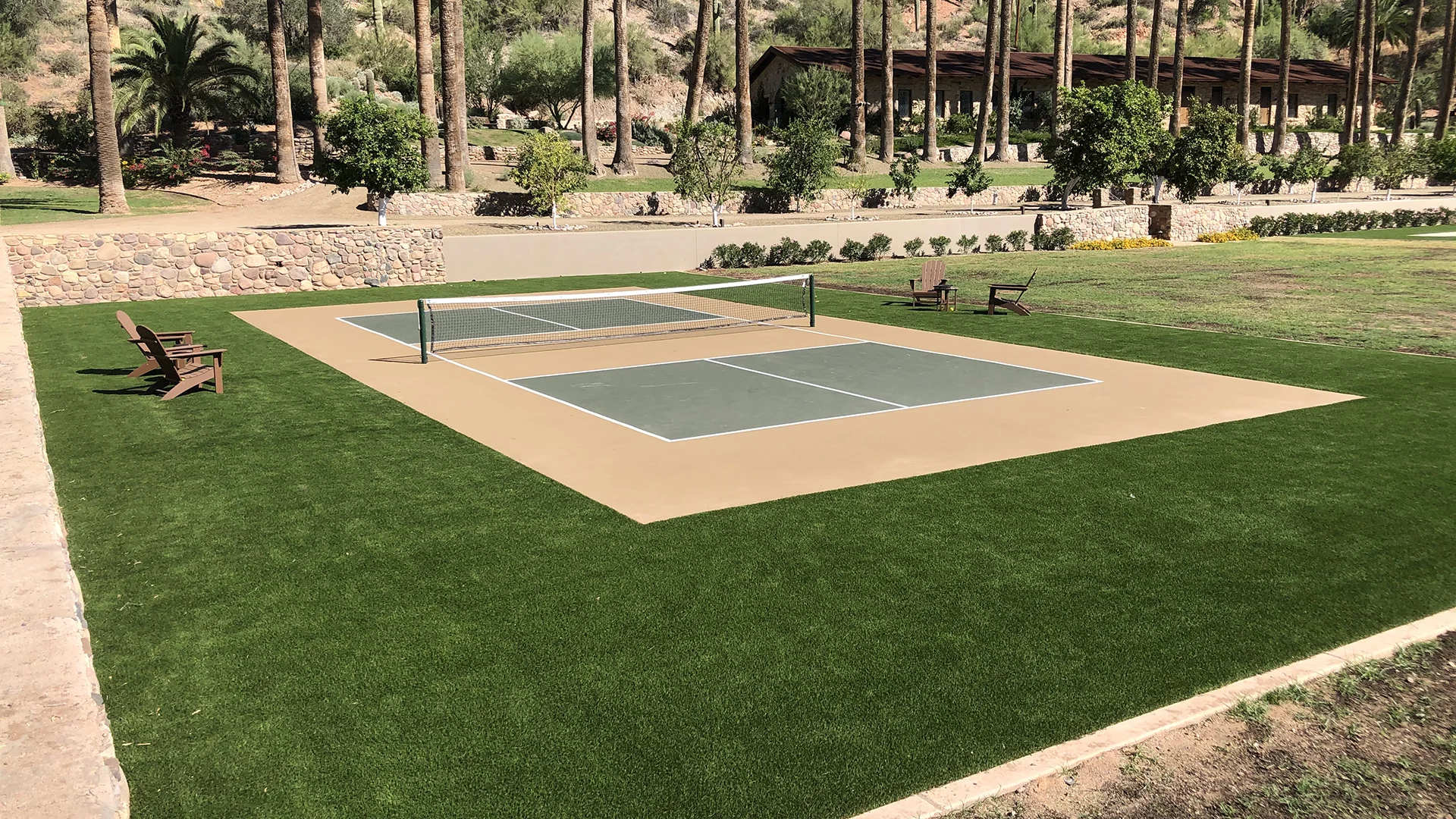 Acrylic pickleball court surrounded by a turf installation